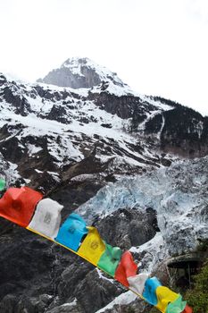 Buddhist tibetan prayer flags flying with mountain