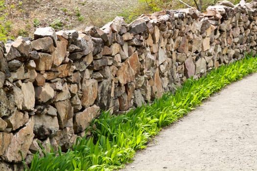 Walking path flanked by wall stone in countryside