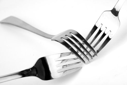 Shiny stainless steel forks on a white background