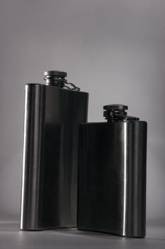 One of the most favorite men's toy - a metal flask for alcoholic beverages. Two used jars of stainless steel for whiskey or brandy