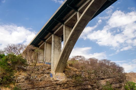 Looking up at a bridge connecting two sides of a canyon