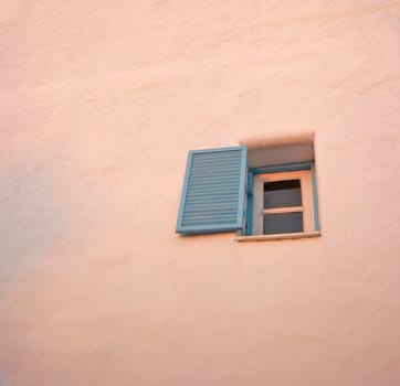 Vintage blue windows on the white wall.