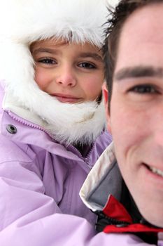 Portrait of a man with little girl by wintertime
