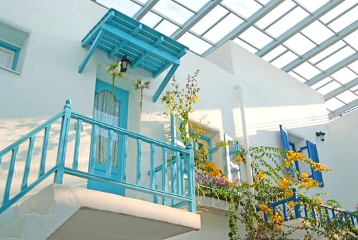 Vintage blue door and window and terrace Decorative with basket flowers on the white wall.