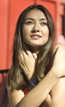 beautiful face of asiatic girl in coral dress