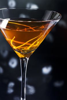 Manhattan cocktail over black and bright sparkles