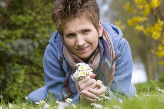 young woman resting on the grass in the park 