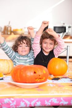 Happy children with carved pumpkins