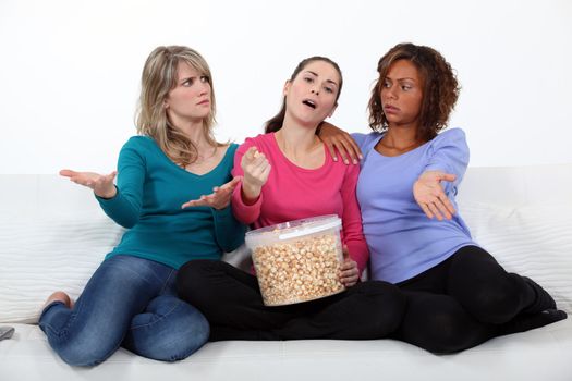 Three woman watching a movie.
