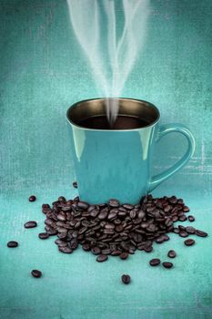 Grungy blue green mug filled with hot black coffee with beans