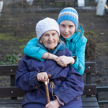 Granddaughter embracing her grandmother on the street