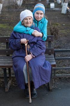 Granddaughter embracing her grandmother on the street