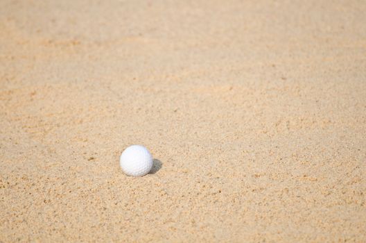 Golf ball in a sand trap.