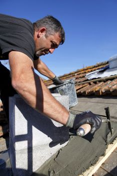 Roofer spreading cement
