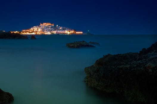 Night image of the Spanish city of Peniscola, on the shores of the Mediterranean, surrounded by the calm sea