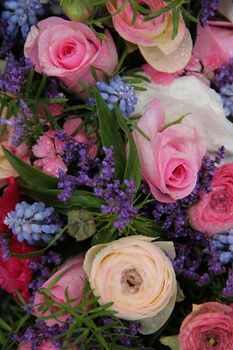 pink roses and ranonkels, blue common hyacints in a spring flower wedding centerpiece