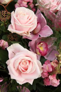 Soft pink rose and orchid in a bridal bouquet