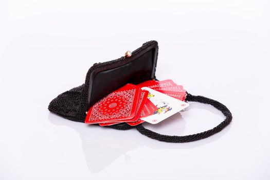 Small black lady handbag and red play cards