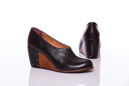 Pair of woman leather original shoes with wedge sole