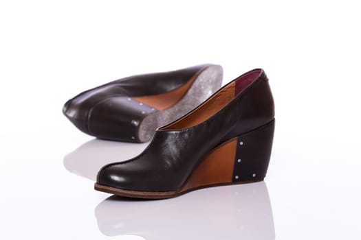 Pair of woman leather original shoes with wedge sole