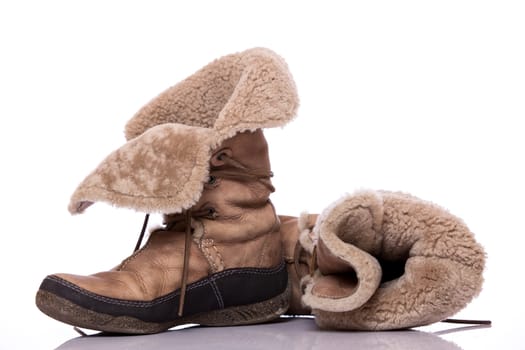 Winter warm brown fur shoes on white background