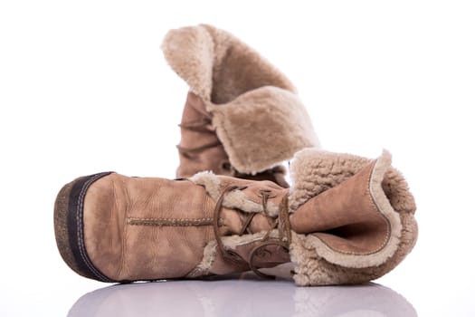 Winter warm brown fur shoes on white background