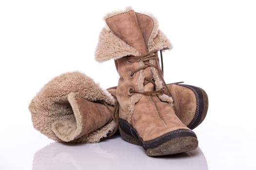 Winter warm brown fur shoes on white background