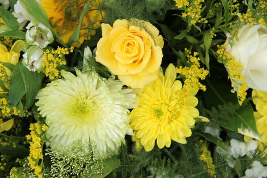 yellow mums and roses in a wedding flower arrangement