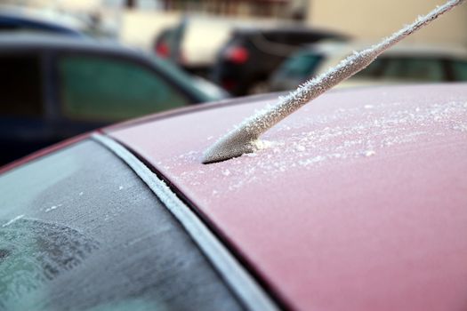 Frozen car window during winter morning
