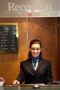 Charming pretty young receptionist posing in front of camera