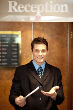 Young man holding an invoice to be delivered to one of the hotel customer