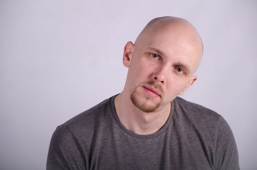 Nice bald guy with a guitar in the studio