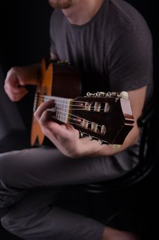 Nice bald guy with a guitar in the studio