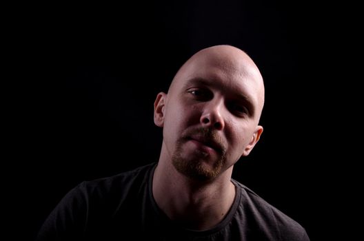 Nice bald guy with a guitar in the studio