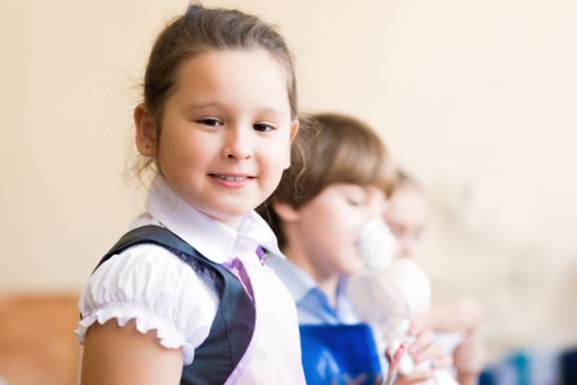 Portrait of Asian girl in apron interested in painting at an art school