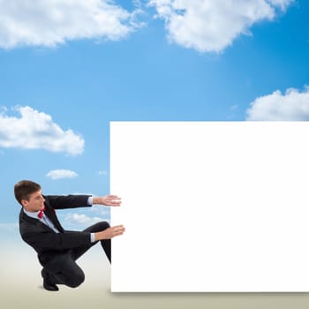 young man holding a blank banner, place for text