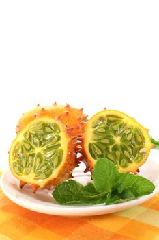 horned melon on a plate with napkin on a light background
