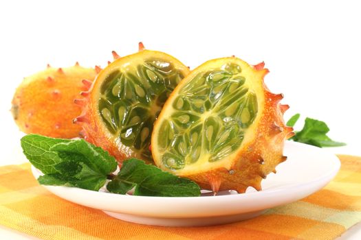 sliced horned melon on a plate with napkin on a light background