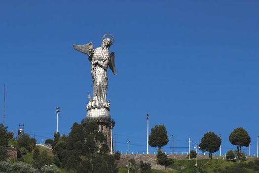 View of the statue of the Madonna at the top of the hill El Panecillo overlooking the city of Quito, Ecuador