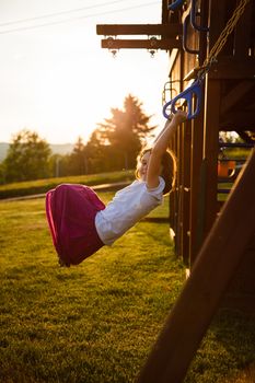 Girl at the rings in a playground