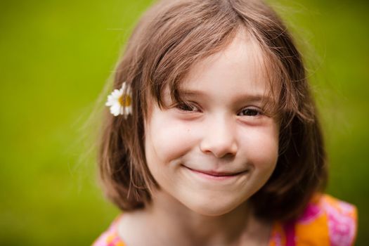 Girl smiling with a flower in her hair