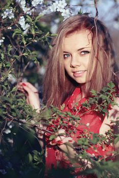 Beautiful girl in a red dress in the colors of cherry