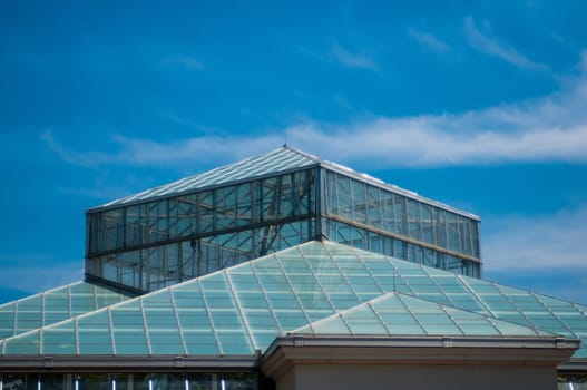 blue glass roof structure and sky