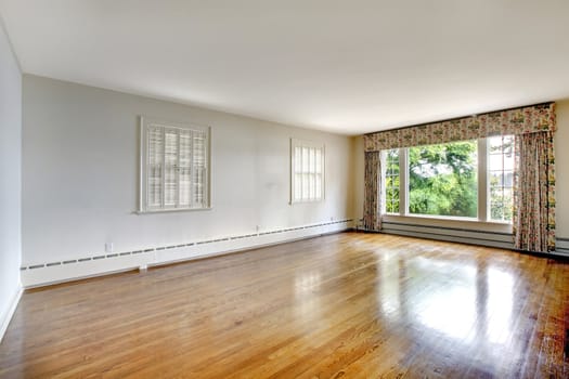 Large elegant luxury historical home empty bedroom with shiny hardwood floor.