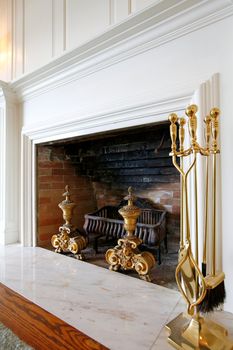 Old wood fireplace with white mental and antique inserts.