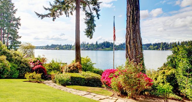 View of the lake and American flug with spring landscape. Lakewood, WA.