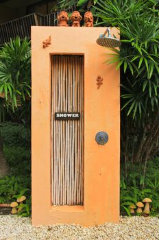 Outdoor shower near swimming pool in tropical style