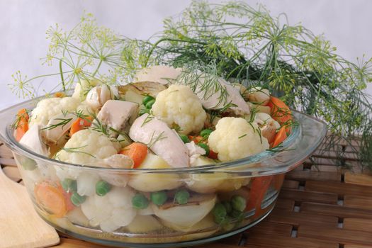 Roasted vegetables with slices of chicken and fennel in a pan