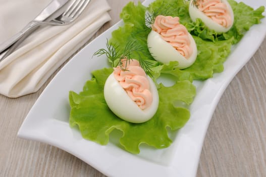 Eggs stuffed with salmon pate in lettuce leaves