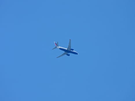 plane flying in a blue sky